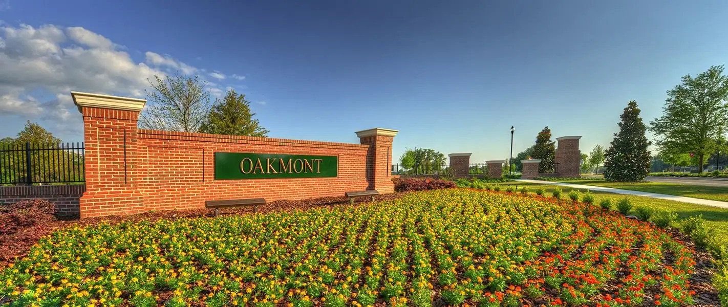 Main entrance to the Oakmont master-planned community in Gainesville, FL, featuring its landmark signage (Image 2).