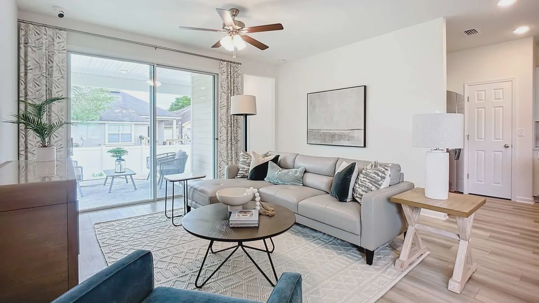 Discover refined elegance with sleek furnishings and abundant natural light in Panther Creek's luxurious living area.