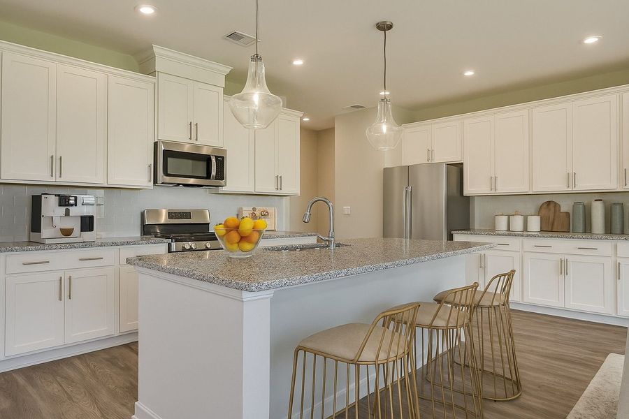 Spacious kitchens with large islands and ample cabinet and counter space