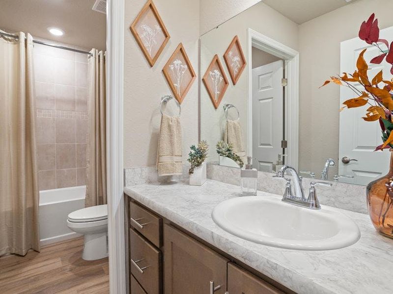 An upstairs hall bath serves the secondary bedrooms - Mariposa townhome by Highland Homes