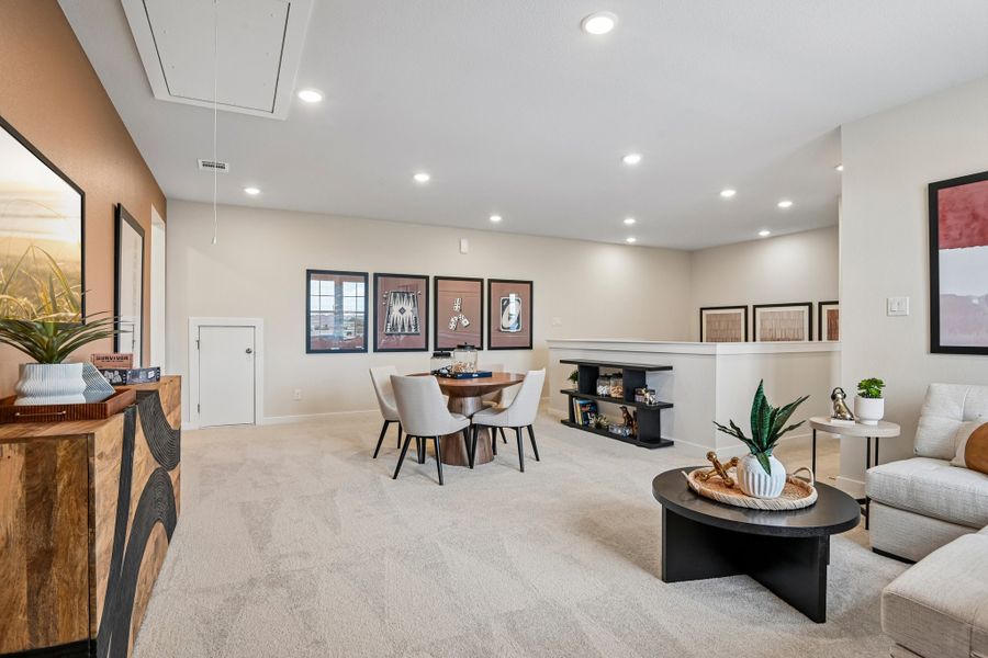A large living room with a dining table and chairs.