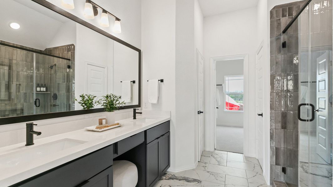 Sleek marble floors and opulent finishes in this Park at Eldridge bath exude luxury and sophistication.