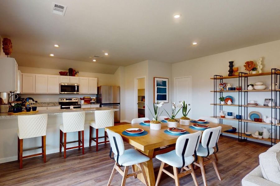 A kitchen with a dining table.