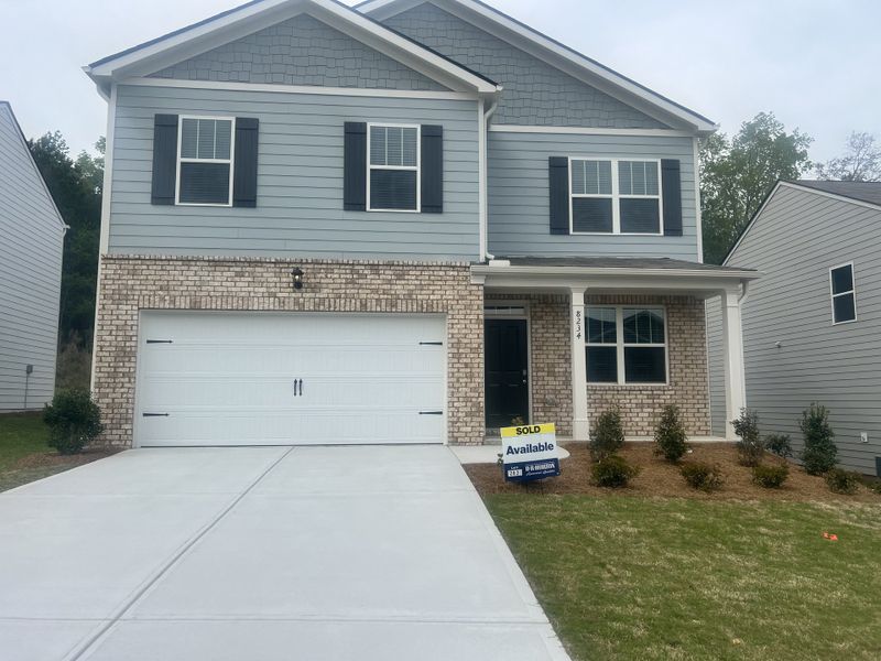 A charming two-story home with brick and siding in Oaks at Cedar Grove by D.R. Horton (Fairburn, GA).