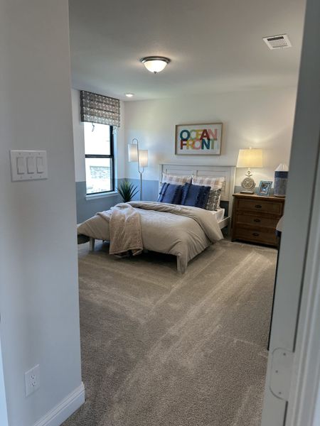 A cozy bedroom with soft carpet, modern decor, a stylish bed, and ambient lighting creates a relaxing atmosphere. A cozy bedroom with soft carpet, modern decor, a stylish bed, and ambient lighting creates a relaxing atmosphere.