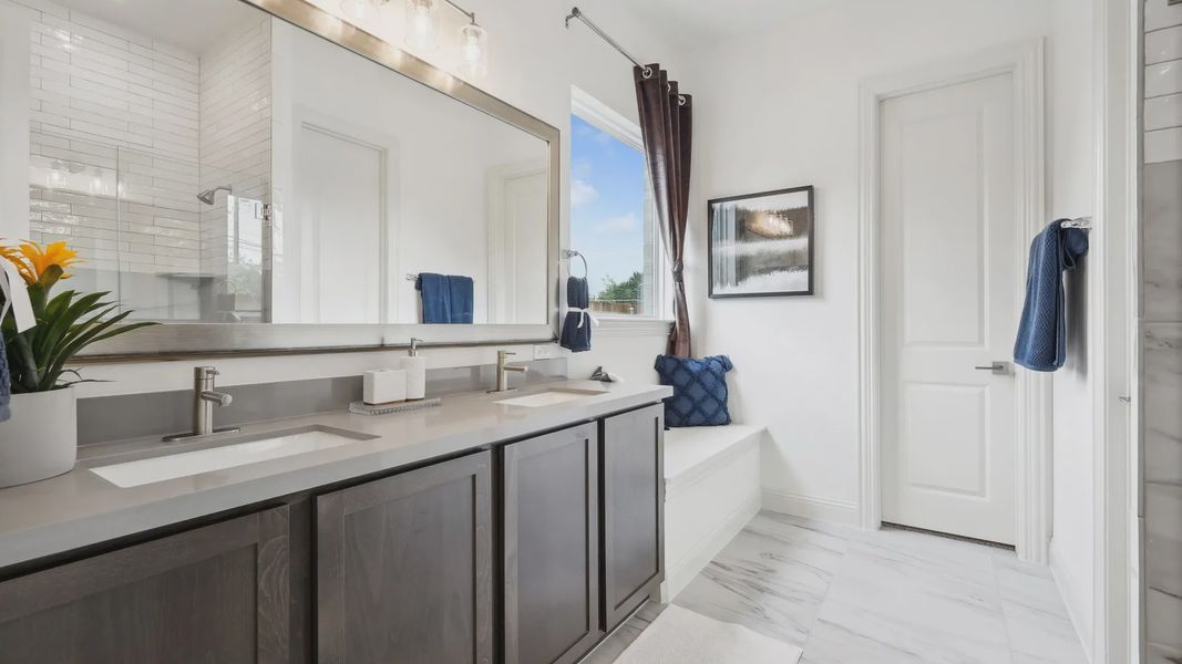 Indulge in luxury with a sleek double vanity and pristine marble flooring in Heritage Park.