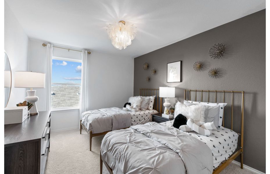Modern guest bedroom with gorgeous accent wall available in new homes at Vista Real in Converse, TX