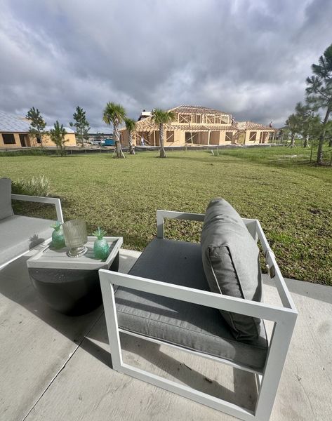 A cozy outdoor patio with modern seating overlooking new constructions in Cherry Elm at SilverLeaf by Dream Finders Homes (St. Augustine, FL). A cozy outdoor patio with modern seating overlooking new constructions in Cherry Elm at SilverLeaf by Dream Finders Homes (St. Augustine, FL).