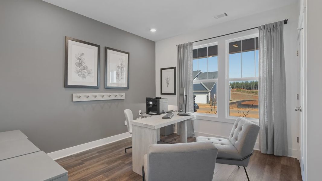 DRB Homes' Walnut Ridge with office space with gray accent wall, large windows, and hardwood flooring in Inman, SC
