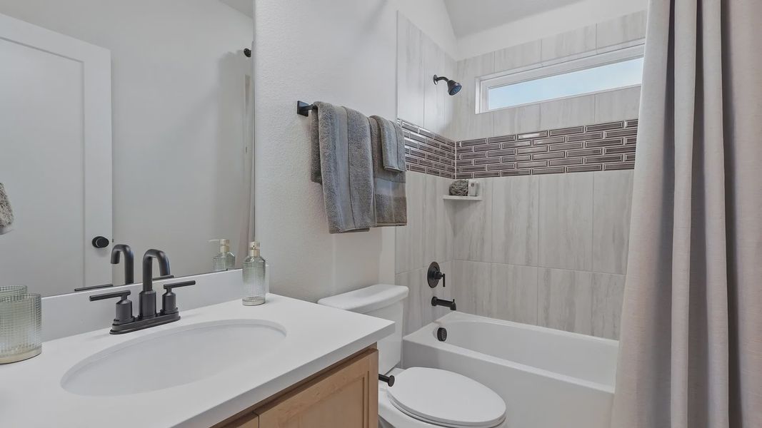 Marble tiles accentuate luxury, complemented by sleek fixtures in Westridge's refined bathroom design.