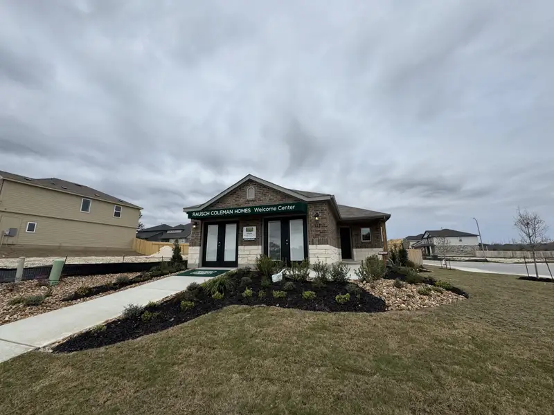 A welcoming Rausch Coleman Homes center with tidy landscaping in Hunters Ranch, San Antonio, TX.