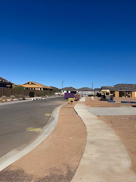 New homes under construction along a wide street in The Enclaves at Desert Oasis by KB Home, Surprise, AZ. New homes under construction along a wide street in The Enclaves at Desert Oasis by KB Home, Surprise, AZ.