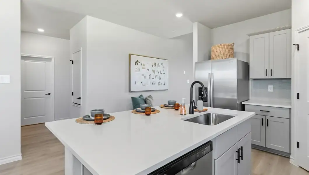 Furnished interior in a model home at The Woodlands at Medina Hills in Mico (Image 26).