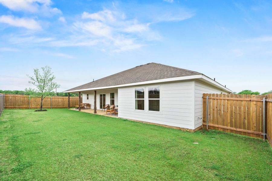 A house with a fence and grass. A house with a fence and grass.