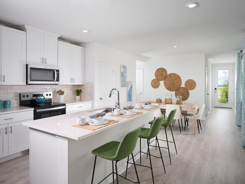 Kitchen and dining room in the Everglade floorplan modeled at Hamilton Bluff