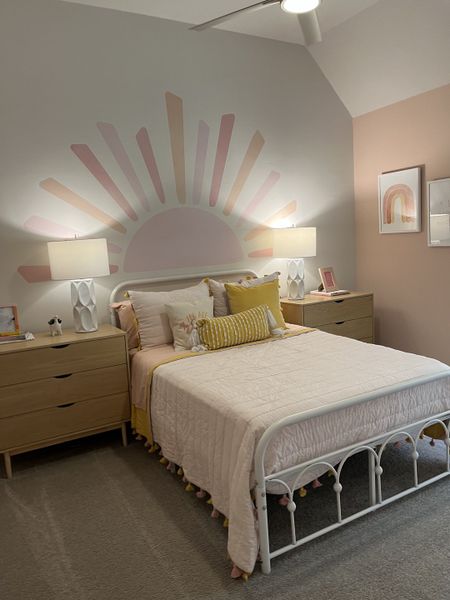 A cozy bedroom with a sunburst mural, soft bedding, and modern decor accents for a charming atmosphere. A cozy bedroom with a sunburst mural, soft bedding, and modern decor accents for a charming atmosphere.