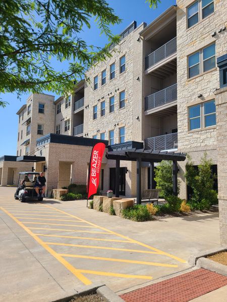 A modern stone-faced building with lush landscaping at Gatherings at Twin Creeks by Beazer Homes (Allen, TX). A modern stone-faced building with lush landscaping at Gatherings at Twin Creeks by Beazer Homes (Allen, TX).