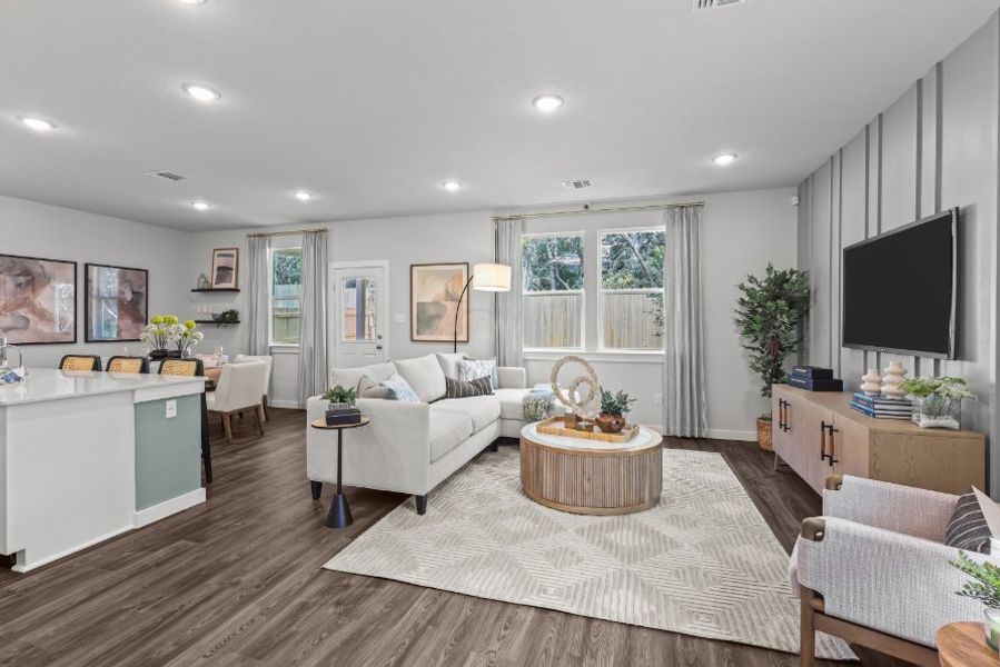 A living room with a large television. A living room with a large television.