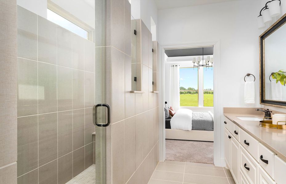 Owner's bath spa shower and dual sinks in Palmary floor plan at Del Webb Fulshear 55+ community