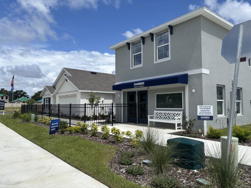 A modern two-story home with a landscaped yard in Emerson Pointe by D.R. Horton (Ocala, FL).