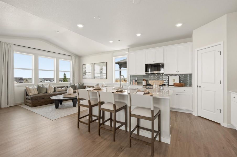 A large kitchen with a dining table. A large kitchen with a dining table.