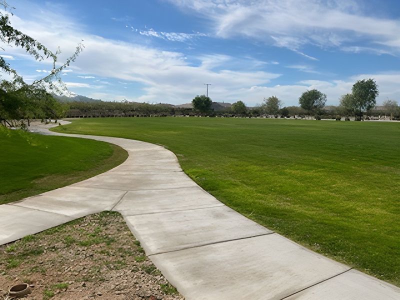 A scenic pathway winds through lush greenery in Rio Rancho Estates by D.R. Horton (Surprise, AZ).
