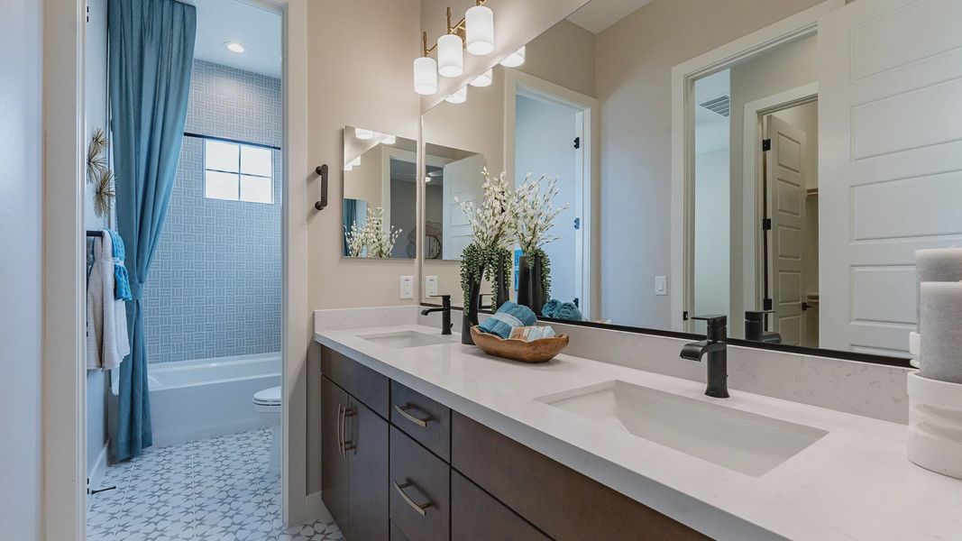 Stunning dual-sink vanity with chic lighting and geometric tiles, reflecting Arroyo Seco luxury. Stunning dual-sink vanity with chic lighting and geometric tiles, reflecting Arroyo Seco luxury.