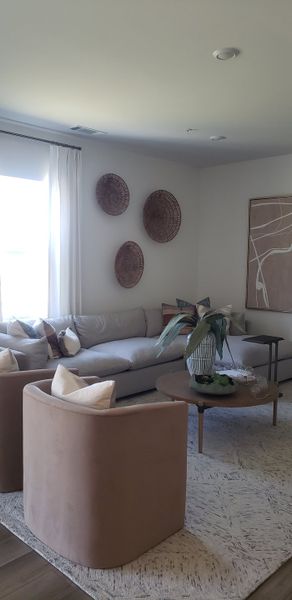 A stylish living room with a cozy gray sofa, modern decor, and soft lighting, featuring elegant earth-tone accents.