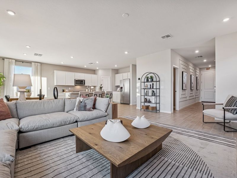 A large living room with a large wood floor and a large glass wall.