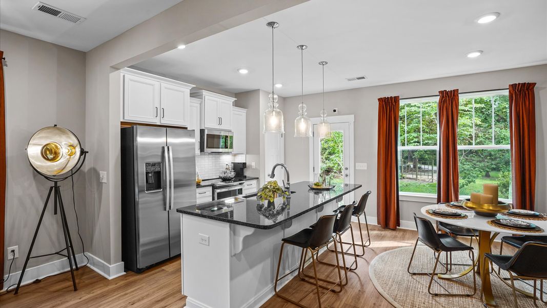 Beautiful kitchen with brown cabinets in Arden, NC at Clayton Crossing Beautiful kitchen with brown cabinets in Arden, NC at Clayton Crossing