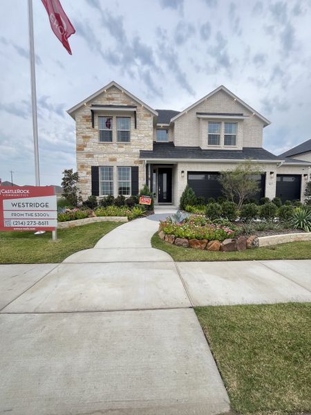 A charming brick home with landscaped yard and elegant shutters in Westridge by CastleRock Communities (McKinney, TX).