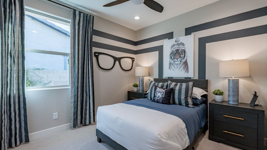 Discover chic striped wall designs and elegant furnishings in this Mystic enclave's luxurious bedroom.