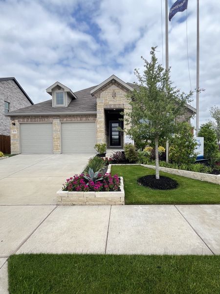 A charming stone facade home with lush landscaping in Simpson Crossing - Signature Series by Meritage Homes (McKinney, TX). A charming stone facade home with lush landscaping in Simpson Crossing - Signature Series by Meritage Homes (McKinney, TX).