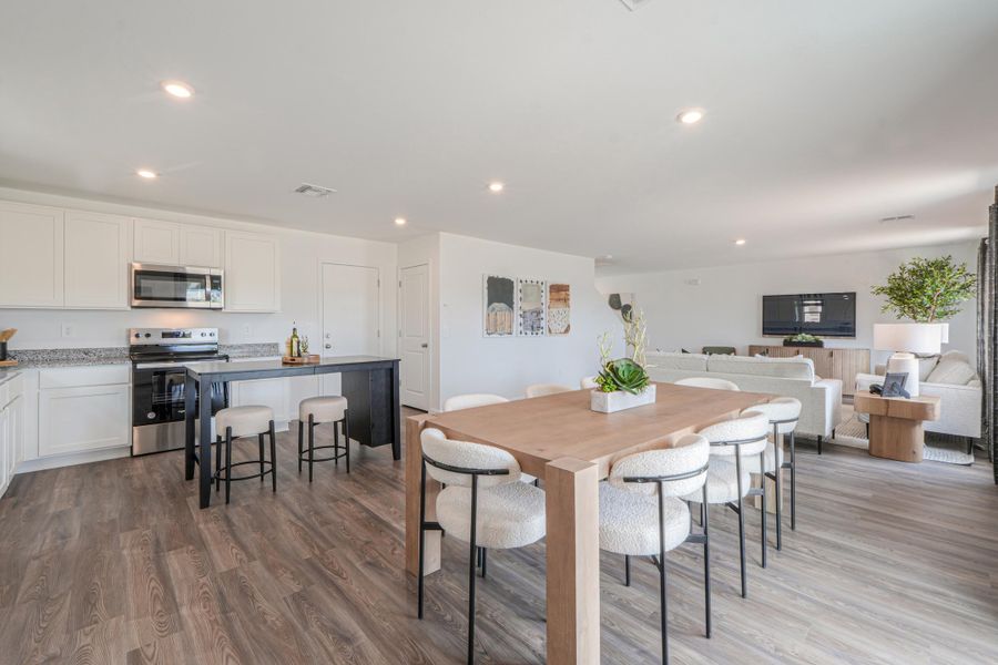 A kitchen with a table and chairs. A kitchen with a table and chairs.
