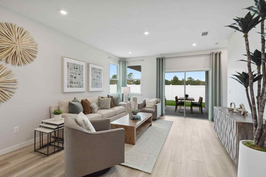 A living room with a large glass door. A living room with a large glass door.