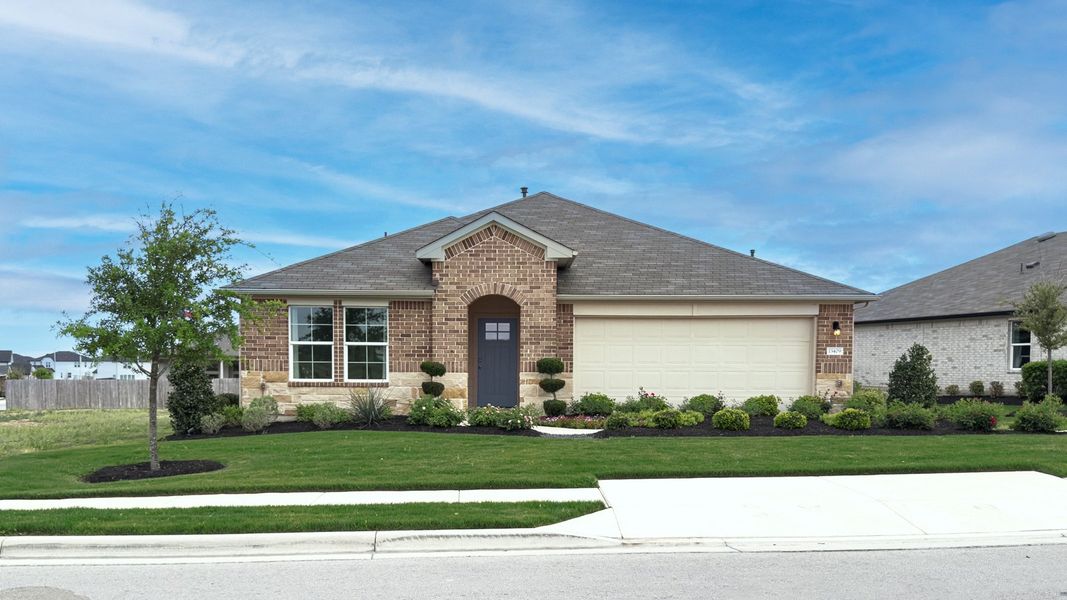Front exterior of a home in the Carillon community, located in Manor, TX (Image 3).