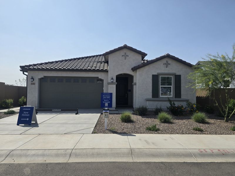 A charming Southwest-style home with a tiled roof and landscaped yard in Hawes Crossing: Discovery by Lennar (Mesa, AZ). A charming Southwest-style home with a tiled roof and landscaped yard in Hawes Crossing: Discovery by Lennar (Mesa, AZ).