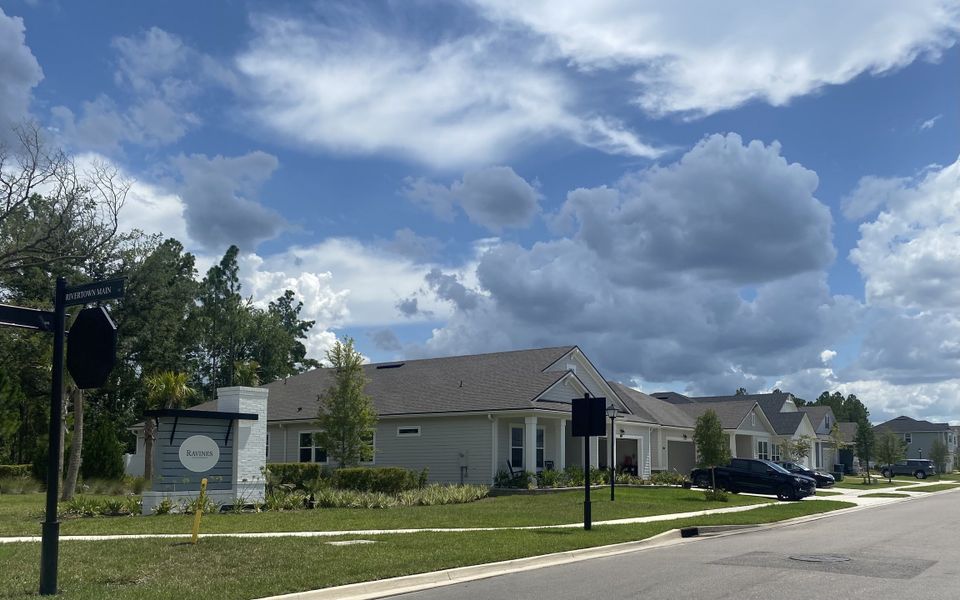 A picturesque neighborhood with charming homes and lush greenery in RiverTown - Ravines by Mattamy Homes (St. Johns, FL).