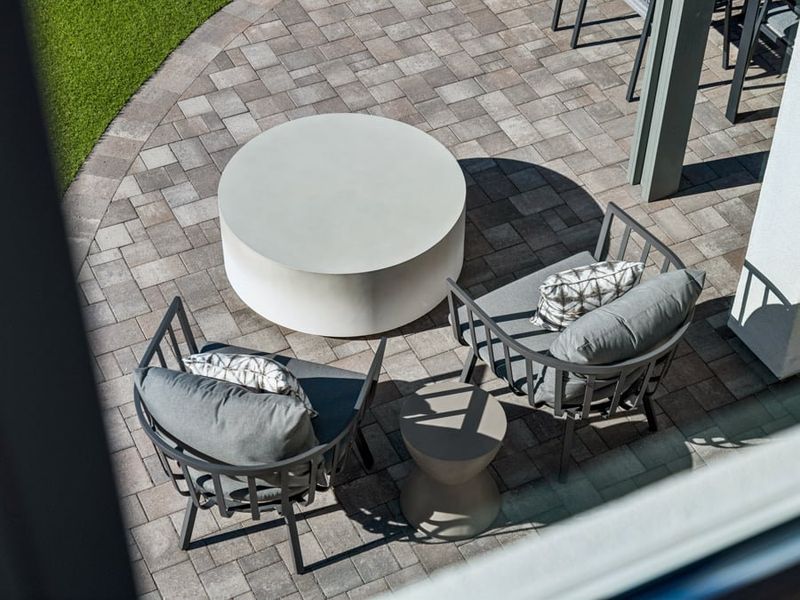 A patio with a table and chairs.