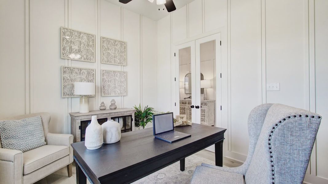 Sophisticated paneling and exquisite decor enhance this Veranda community home office.