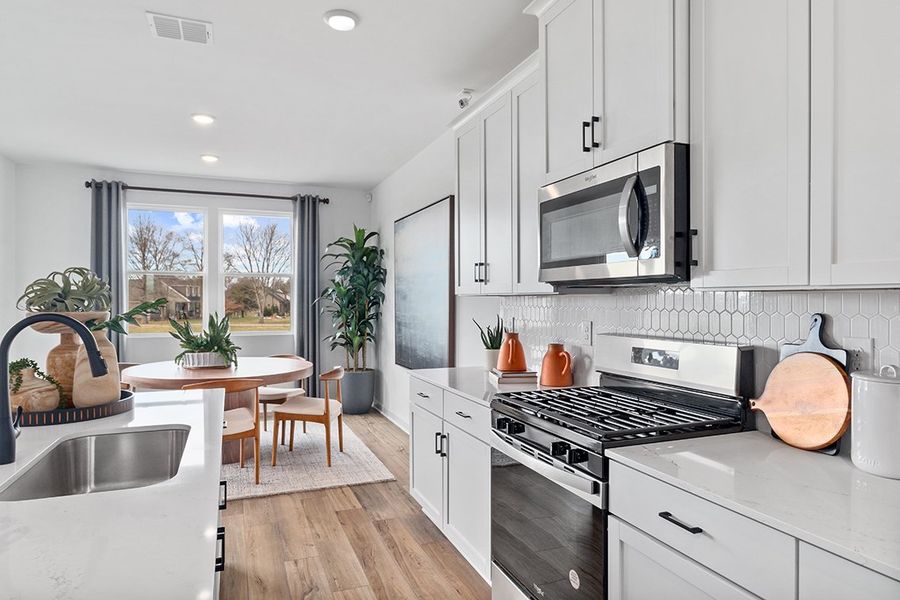 A kitchen with white cabinets. A kitchen with white cabinets.