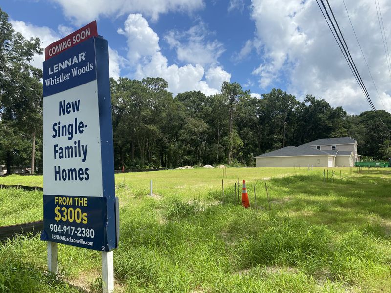 New single-family homes coming soon in Whistler Woods by Lennar in Jacksonville, FL. Lush green setting under a bright sky.