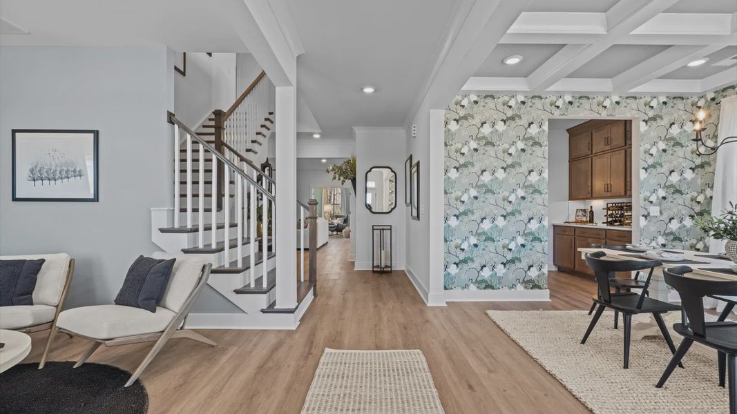 Stunning entryway with hardwood flooring, elevated ceilings, and views of den and dining room at Pinebrook by DRB Homes Stunning entryway with hardwood flooring, elevated ceilings, and views of den and dining room at Pinebrook by DRB Homes