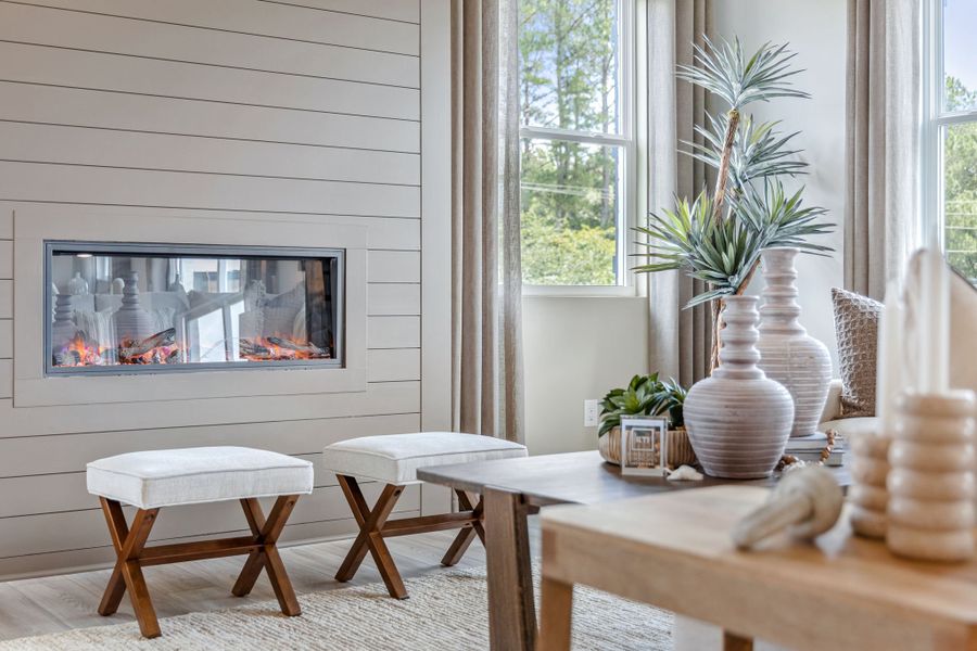 A living room with a table and chairs.