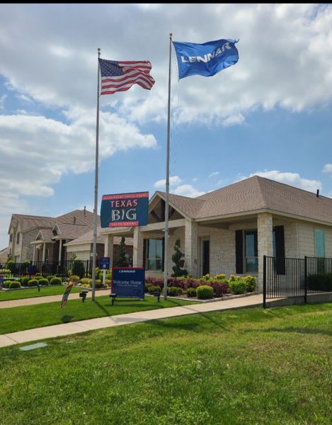 A charming stone home with manicured landscaping in Preserve at Honey Creek by Lennar, McKinney, TX.