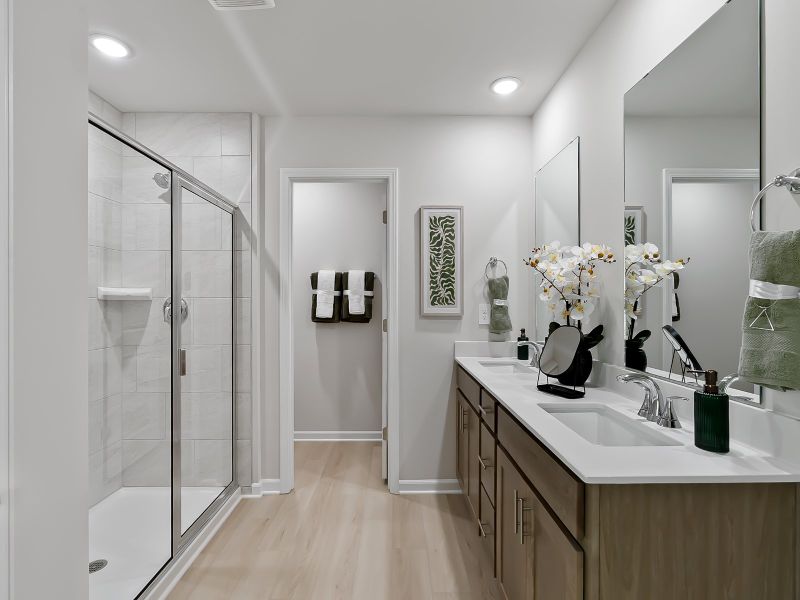 Unwind in the spacious primary suite featuring an ensuite bath, dual sinks and a walk-in closet.