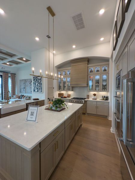 A modern kitchen with sleek cabinetry, a spacious island, elegant pendant lighting, and stainless steel appliances. A modern kitchen with sleek cabinetry, a spacious island, elegant pendant lighting, and stainless steel appliances.
