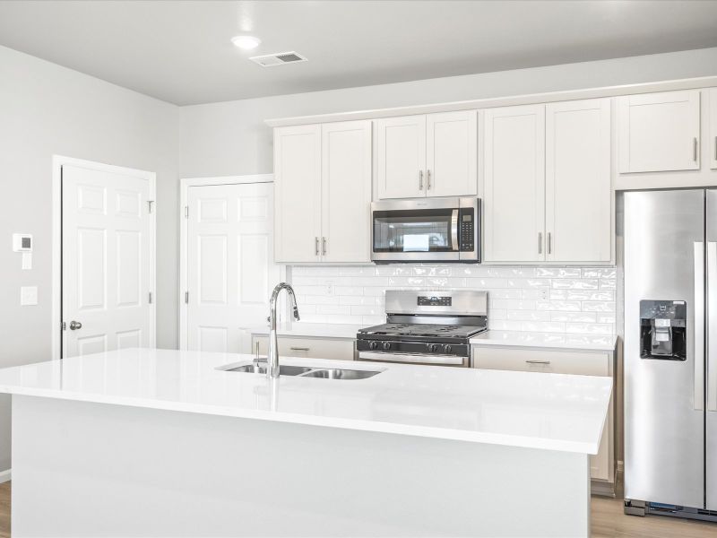 Kitchen in the Woodland floorplan at a Meritage Homes community in Broomfield, CO.