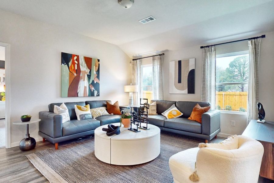 A living room with a couch and a coffee table. A living room with a couch and a coffee table.