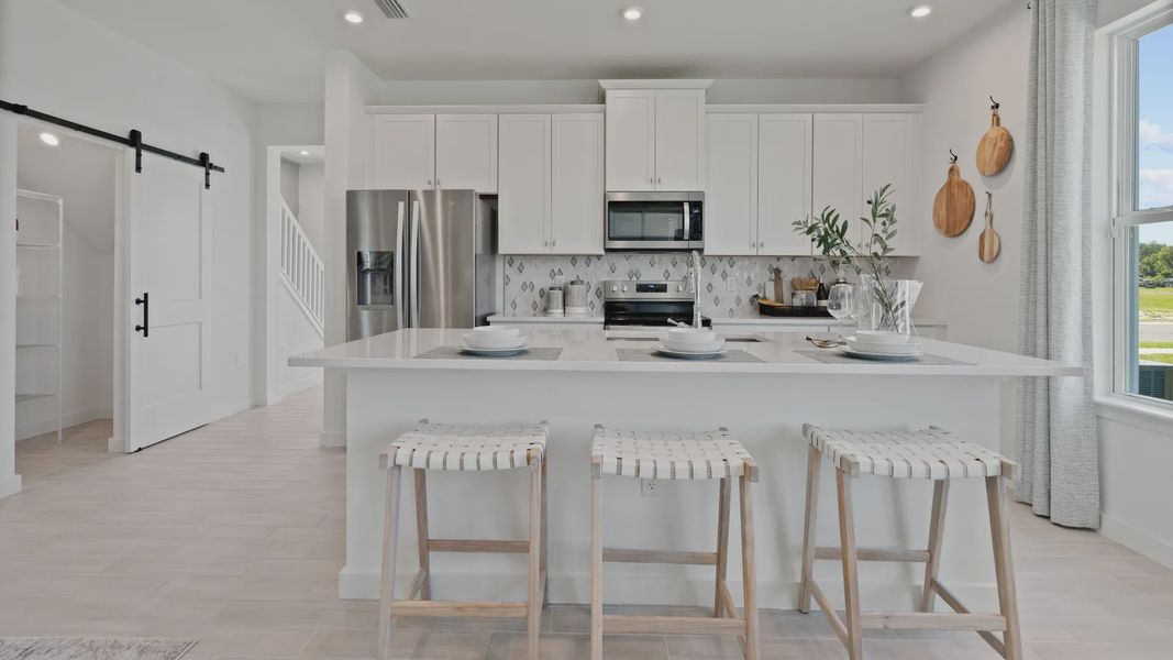 Big kitchen with natural lighting at DRB homes